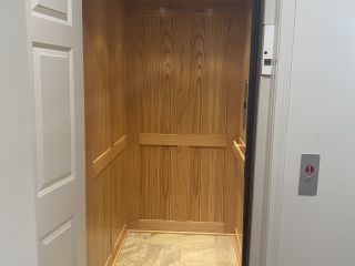 Symmetry Elevating Solutions In Line Gear Drive Residential Elevator with Custom Flooring and an Enterprise Gate