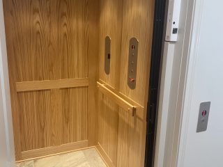 Symmetry Elevating Solutions In Line Gear Drive Residential Elevator with Custom Flooring and an Enterprise Gate