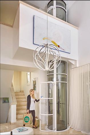 Lady Standing in Living Room Next to a Vacuum Elevator in Pittsburgh, Morgantown, Ithaca, Rochester, Buffalo, Erie