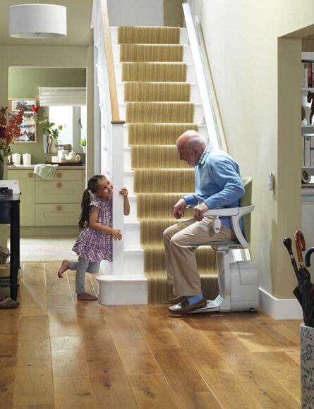 Grandpa Sitting on Straight Stair Lift Talking to Granddaughter in Buffalo, Erie, Rochester, and Ithaca, NY