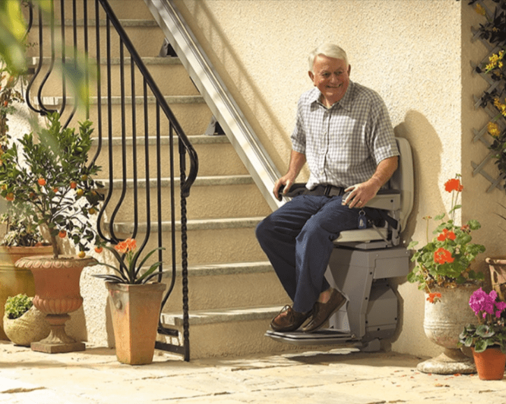 Elderly Man Sitting on a Straight Stair Lift in Buffalo, Rochester, Ithaca, NY, and Erie