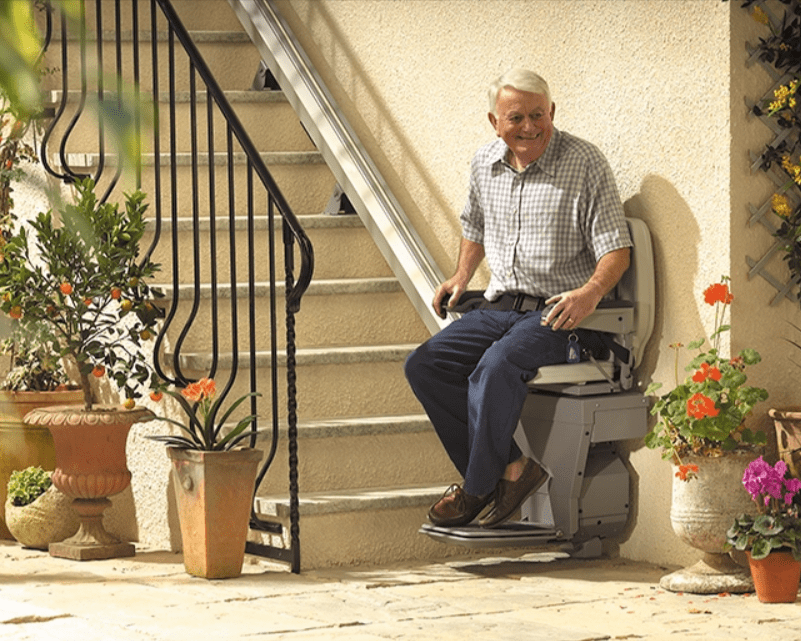 Elderly Man Sitting on a Straight Stair Lifts in Buffalo, Rochester, Erie, and Ithaca, New York