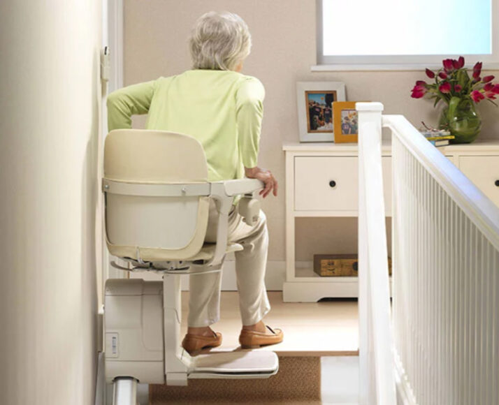 Elderly Woman Getting Up Off of a Stannah Stair Lift in Ithaca, NY, Rochester, Buffalo, Erie