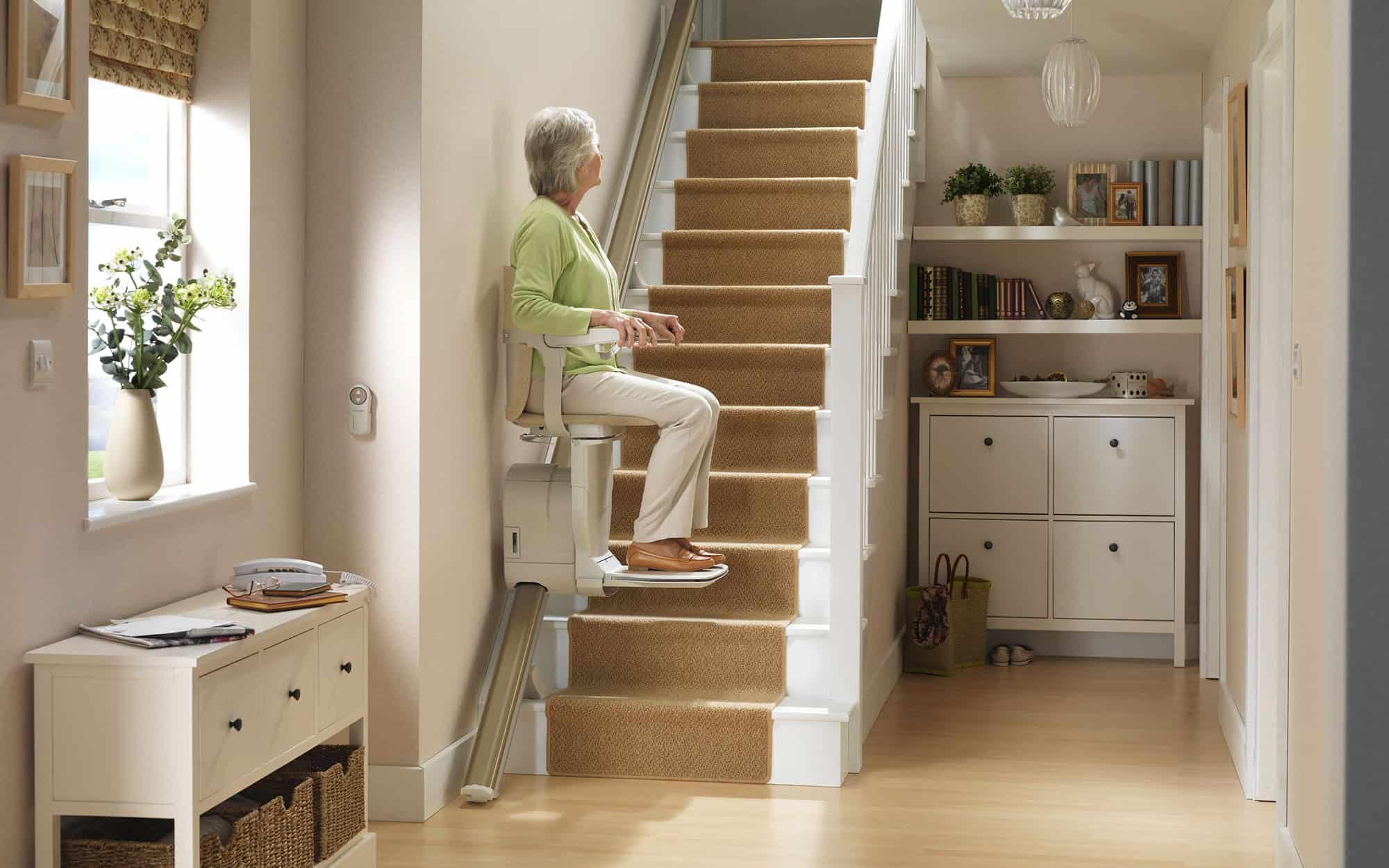 Woman Sitting On Stairlift Going Up
