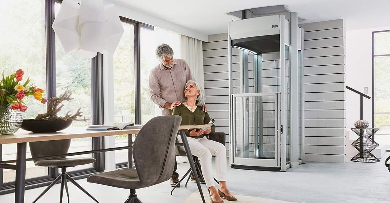 Couple Sitting in Living with with an Elevator in Buffalo, Rochester, Pittsburgh, Ithaca, NY, Erie, and Morgantown, WV.